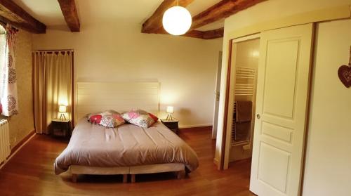 a bedroom with a bed with two pillows on it at Villla DUO in Besançon