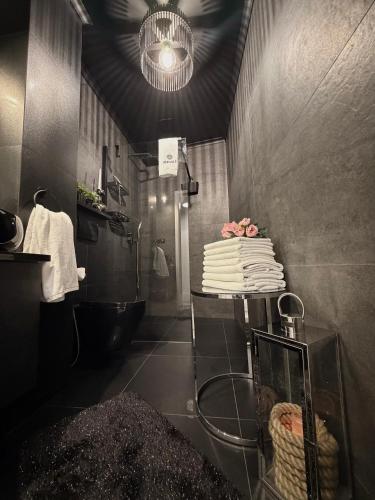 a bathroom with a shower and a cake on a table at Pokład Jurata in Jurata