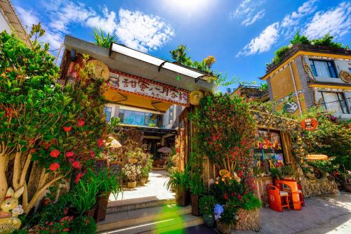 a store with flowers and plants in front of it at Sweet August · Boutique Hotel (Dali Erhai) in Dali