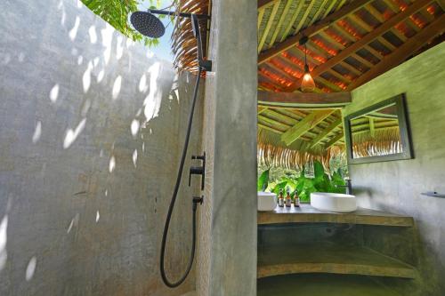 a shower stall in a bathroom with a shower at Huma Terra Lodges in Hikkaduwa