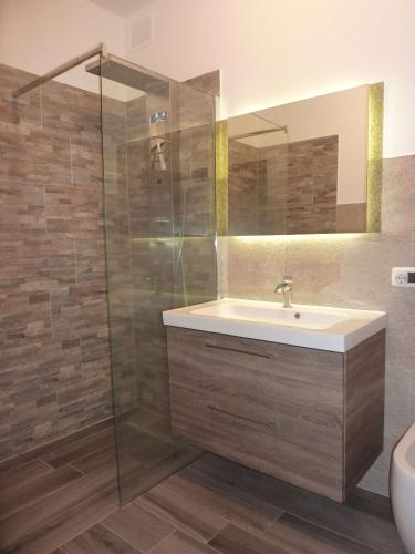 a bathroom with a sink and a shower at BlueVille21 in Germignaga