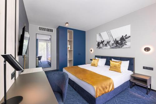 a hotel room with a bed and a tv at LUA Boutique RoomZ- Adults only in Balatonfüred