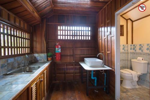 a small bathroom with a sink and a toilet at Grandsiri Resort KhaoYai in Mu Si