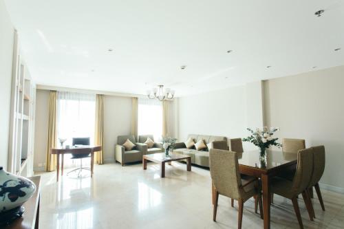a living room with a couch and a table at Thomson Residence Hotel in Bangkok