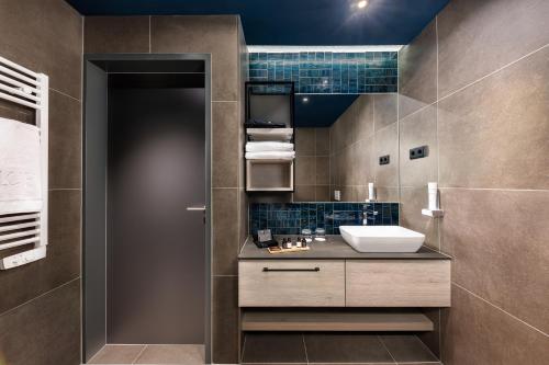 a bathroom with a sink and a mirror at LUA Boutique RoomZ- Adults only in Balatonfüred