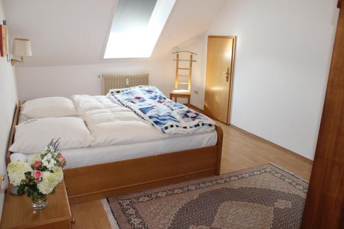 a bedroom with a bed with a table and a ladder at Schenkenhof Proitze in Schnega