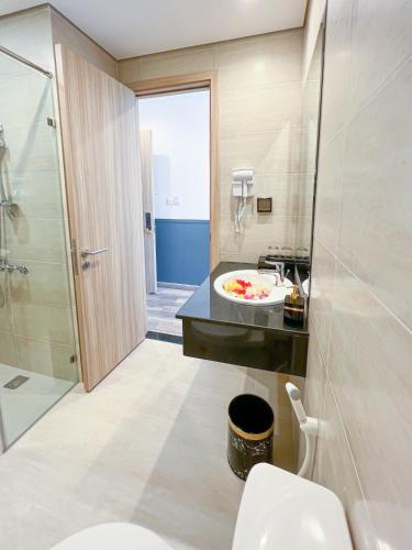 a bathroom with a toilet and a sink and a shower at MARINA SEASIDE BEACH BOUTIQUE Phu Quoc - Infinity Pools - PREMIUM SOLAR ENERGY in Phú Quốc
