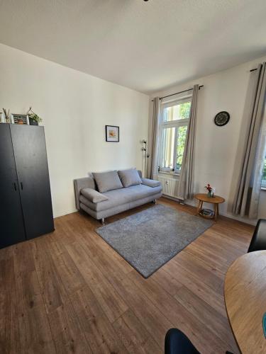 a living room with a couch and a table at Plauen-West in Plauen