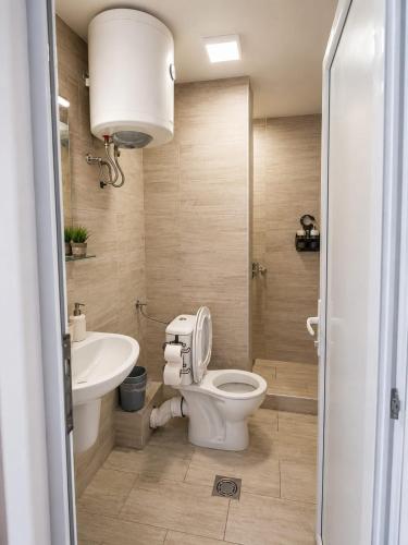 a bathroom with a toilet and a sink at Serenita Stone House in Bečići