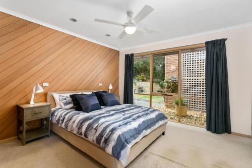 a bedroom with a bed and a window at Rye Coastal Getaway in Rye