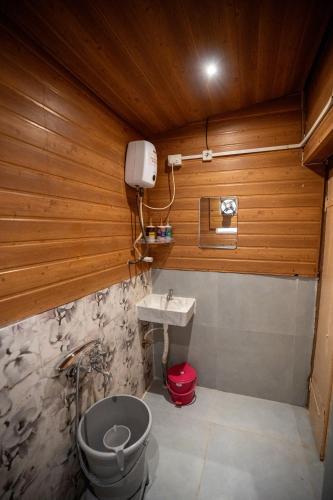 a small bathroom with a sink and a toilet at Giri Mandala The Mountain Vihar in Welhe