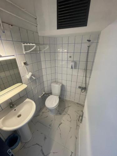 a bathroom with a toilet and a sink at Alevok Hotel in Erdek