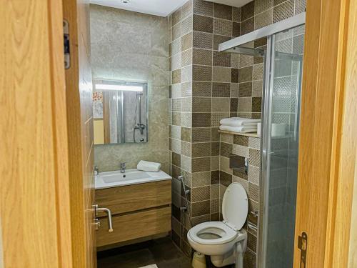 a bathroom with a toilet and a sink at Dominium Residence in Agadir