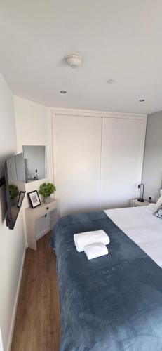 a bedroom with a bed with two towels on it at Modern Executive Studio in Gibraltar