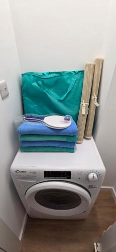 a washing machine with towels on top of it at Modern Executive Studio in Gibraltar