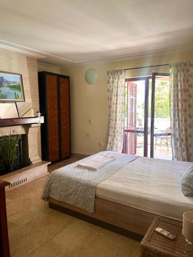 a bedroom with a large bed and a fireplace at Guest House Vila Eli in Herceg-Novi