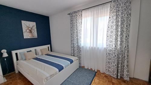 a bedroom with a bed and a large window at Apartment Succulenta in Crno