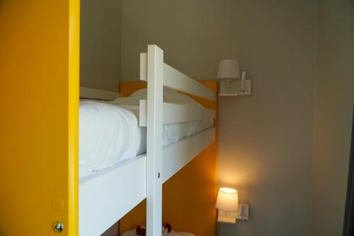 a bedroom with a bunk bed with a mirror at Ô Doubs Chalets in Mouthe