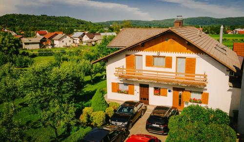 a group of cars parked in front of a house at Lika Story in Josipdol