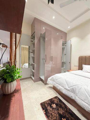 a bedroom with a large bed and a large mirror at CRAZZY HOME stay in Chandigarh Airport