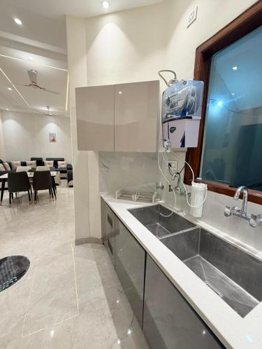a kitchen with a sink and a table with chairs at CRAZZY HOME stay in Chandigarh Airport