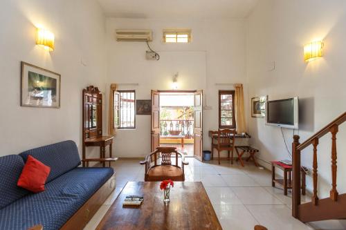a living room filled with furniture and a tv at Casa Cottage in Bangalore