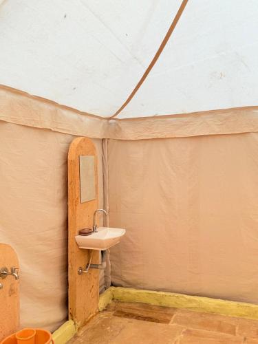 a bathroom with a sink in a tent at Style Heritage Resort & Camp in Sām