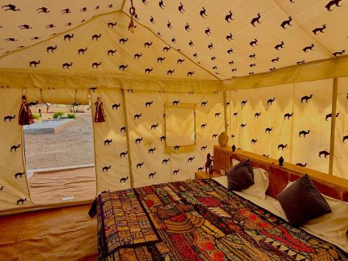 a bedroom with a tent with bats on the ceiling at Style Heritage Resort & Camp in Sām
