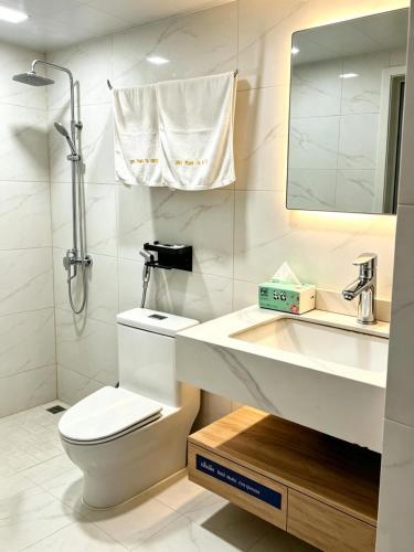 a bathroom with a toilet and a sink and a mirror at zhiyuanta hotel in Vientiane