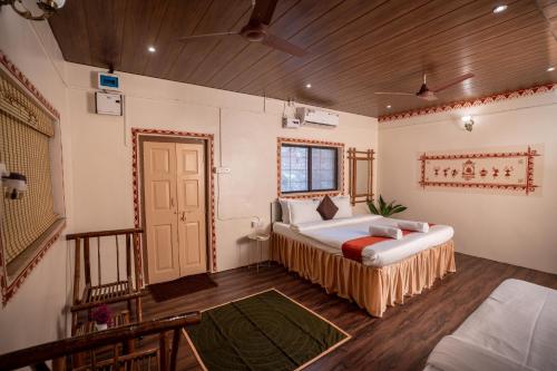a bedroom with two beds and a door at Giri Mandala The Mountain Vihar in Welhe