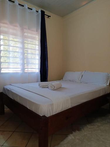 a bed with two towels on it in a bedroom at Diani Escape in Ukunda