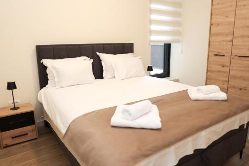 a bedroom with a large bed with two towels on it at SKYHILL 1 O1 Jahorna in Jahorina