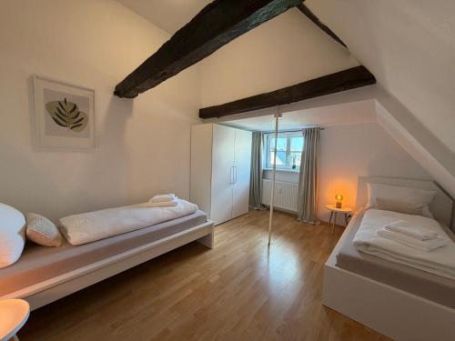 a large room with two beds and a window at Marktplatzapartment 2 in Höxter