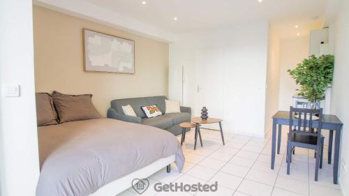 a bedroom with a bed and a chair at La Villette - Charming flat in Pantin - GetHosted in Pantin