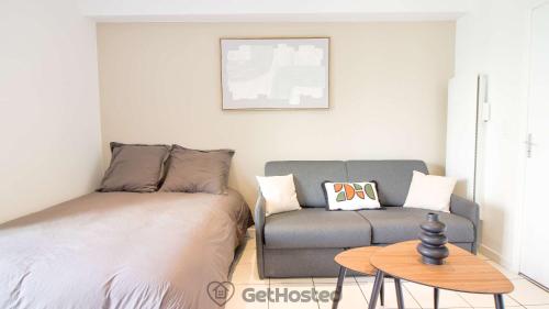 a living room with a bed and a couch at La Villette - Charming flat in Pantin - GetHosted in Pantin