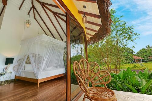 a bedroom with a bed and a table and chairs at Huma Terra Lodges in Hikkaduwa
