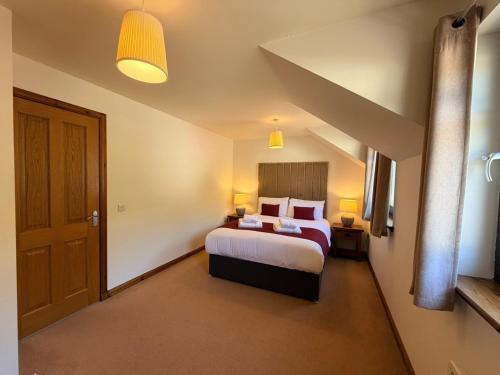 a hotel room with a bed and a door at The Galleries No 2 in Spean Bridge