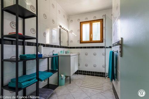 a bathroom with a shower and a sink and a mirror at Le Clos in Anthien
