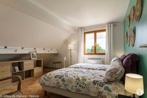 a bedroom with a bed and a window at Le Clos in Anthien