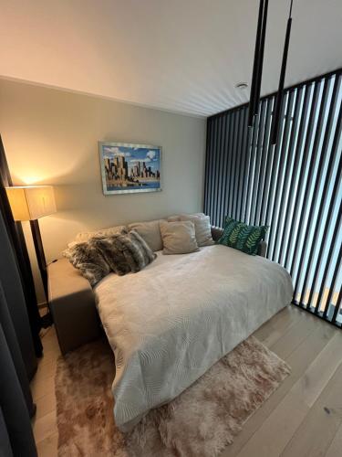 a bed in a room with a large window at Kvissentali House in Tartu