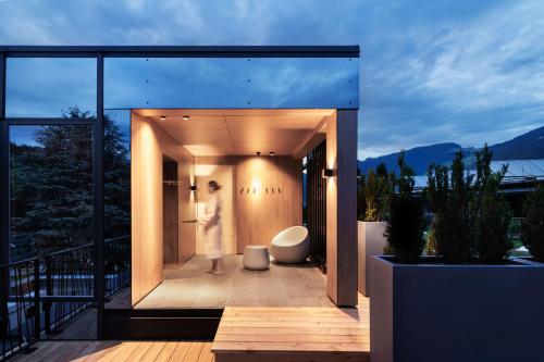 a glass house with a toilet on a deck at Natürlich Hell - Camping & Aparthotel in Fügen
