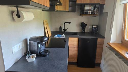 a small kitchen with a coffee maker on a counter at Pfälzerblick Lambrecht- Ferienwohnung mit Garten in Lambrecht