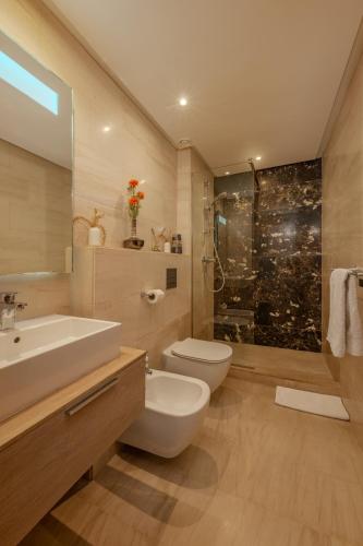 a bathroom with a toilet and a sink and a shower at anfa Louise in Casablanca