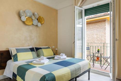 a bedroom with a large bed and a balcony at BluesHouse La Fenice in Bologna