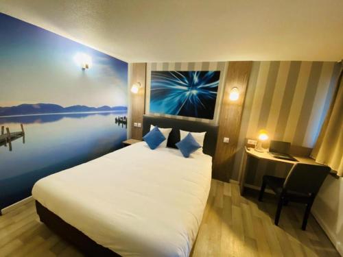 a hotel room with a large bed and a desk at Urban House in Roubaix