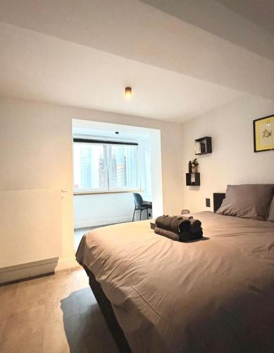 a bedroom with a large bed with a window at Brussels Loft in Brussels