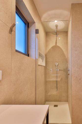 a bathroom with a shower with a glass door at Primelife Carvoeiro in Praia do Carvoeiro