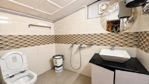a bathroom with a toilet and a sink at Nainital Hill View Boho in Nainital