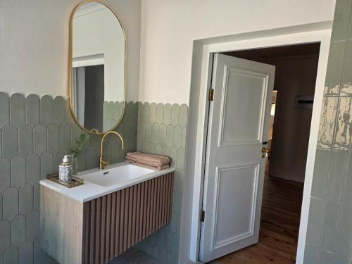 a bathroom with a sink and a mirror at Paul René Manor House in Robertson