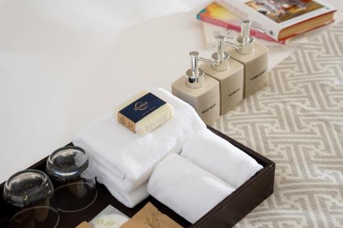 a box of towels and candles on a table at Central Mansions Hotel and Apartments in Phnom Penh
